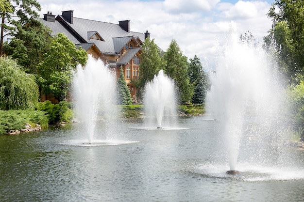 Beautiful pond with fountains at luxurious mansion