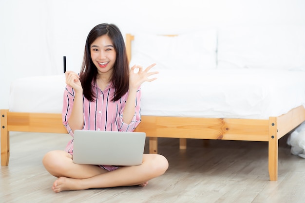 Beautiful portrait asian woman sitting using credit card