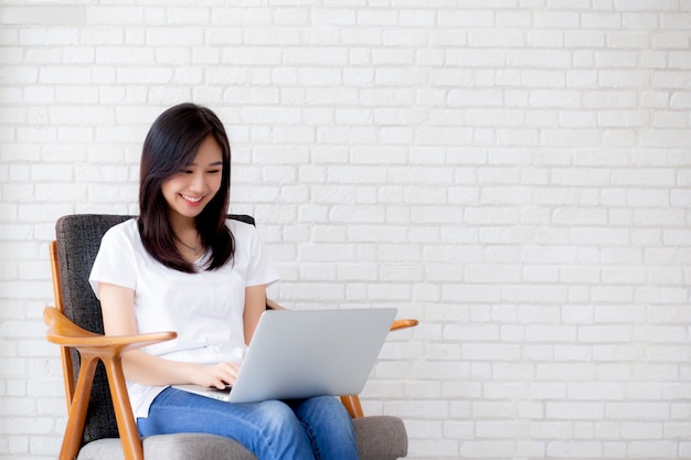 Beautiful portrait asian woman working online laptop