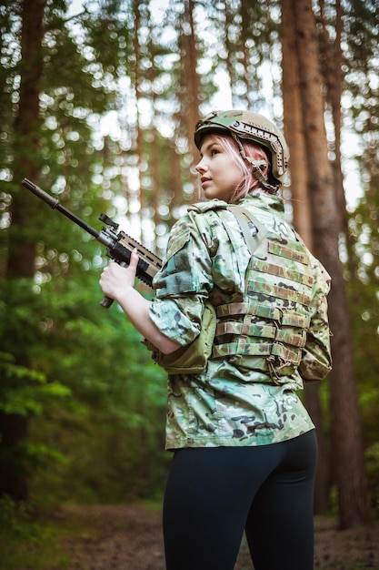 Beautiful portrait of a girl holding a gun