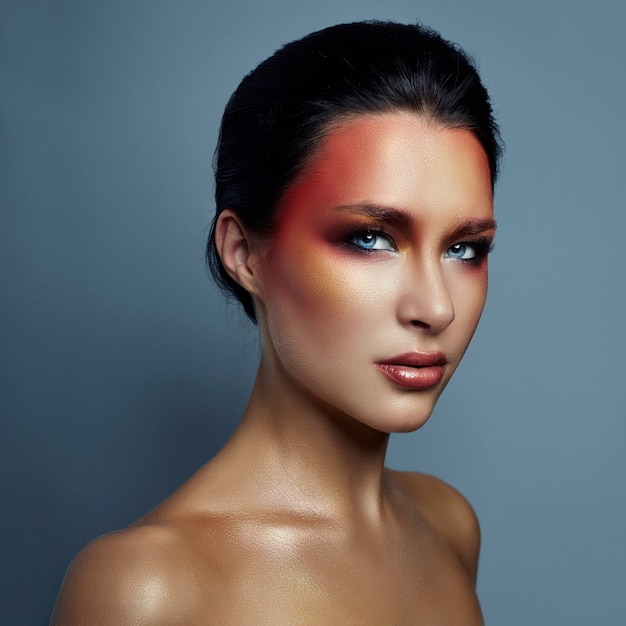 Beautiful portrait of woman with red bright makeup