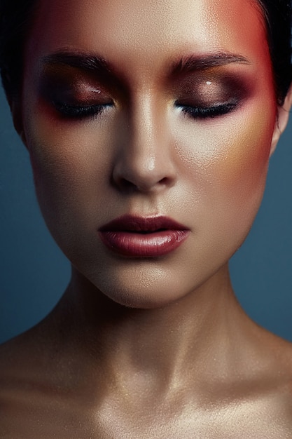 Beautiful portrait of woman with red bright makeup