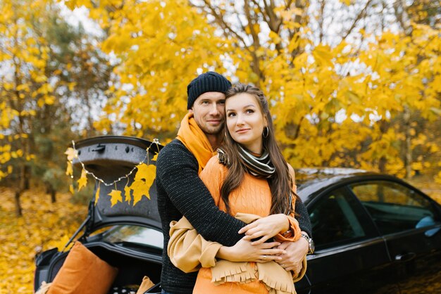 Beautiful portrait of a young couple in the autumn forest