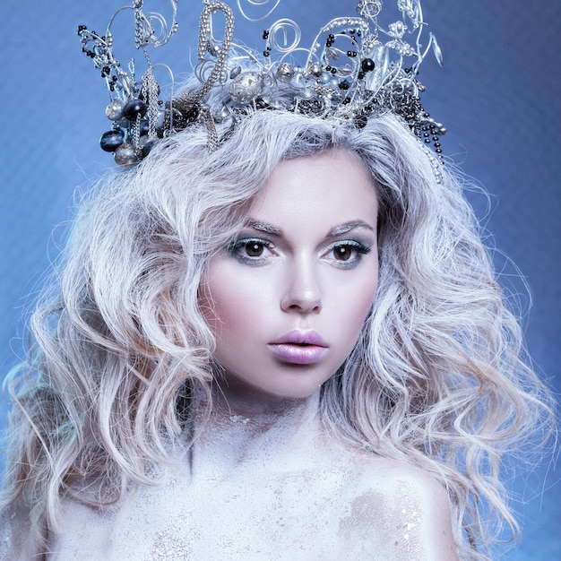 Beautiful portrait of a young girl. The image of a snow queen with a crown on his head