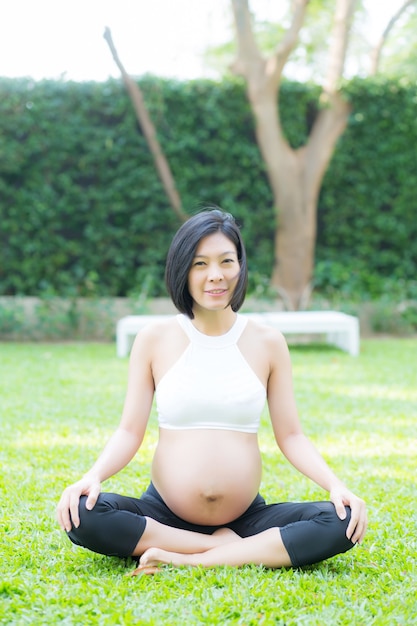 Beautiful pregnant asian young woman relax in the park