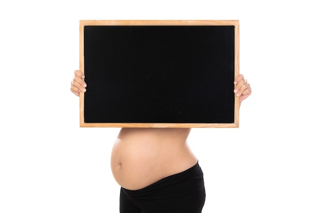 Beautiful pregnant girl holding white empty blackboard