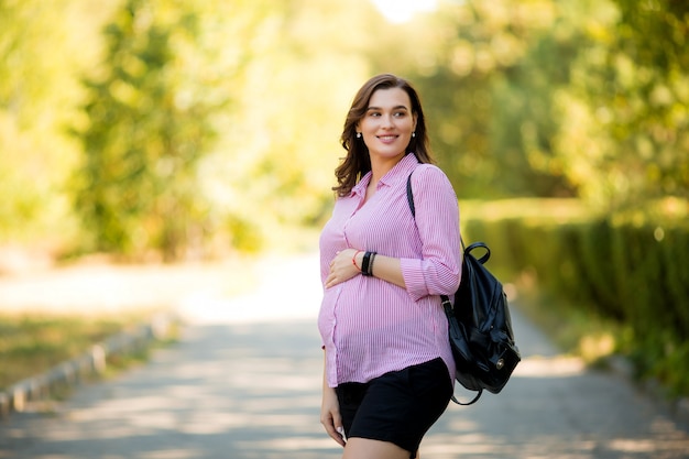 beautiful pregnant girl on a summer walk