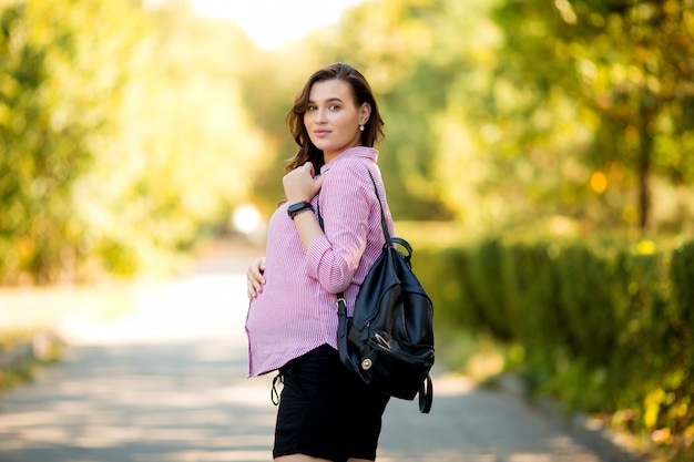 beautiful pregnant girl on a summer walk