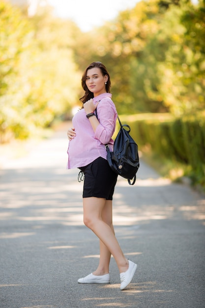 beautiful pregnant girl on a summer walk