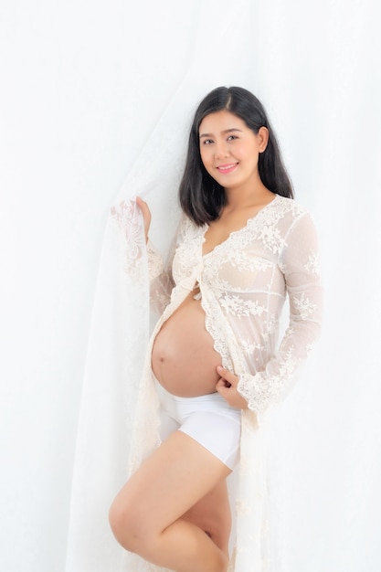 Beautiful pregnant happy woman touching her belly