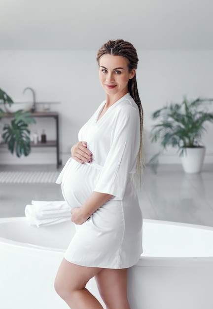 Beautiful pregnant woman in bathroom