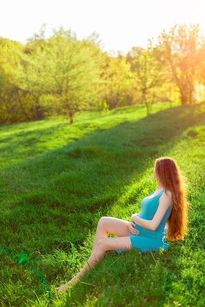 Beautiful pregnant woman in the garden