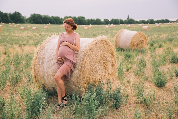 Beautiful pregnant woman in nature outdoors