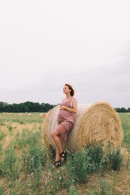 Beautiful pregnant woman in nature outdoors