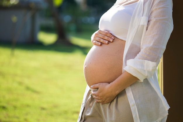 Beautiful pregnant woman in the park