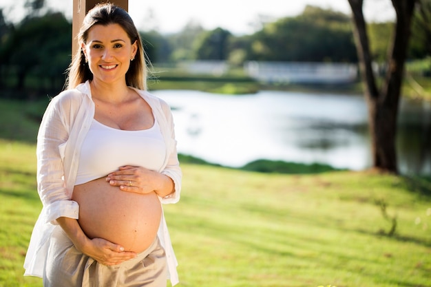 Beautiful pregnant woman in the park