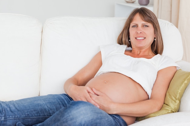 beautiful pregnant woman posing while lying