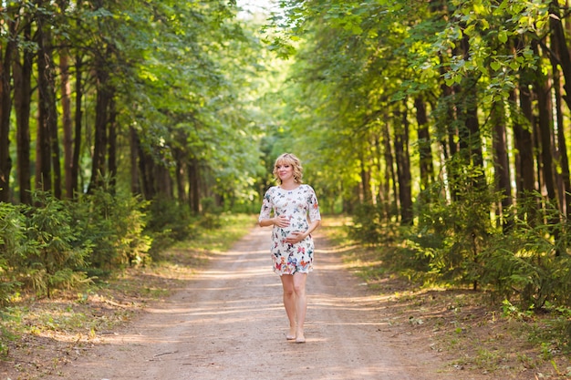 Beautiful pregnant woman relaxing outdoors