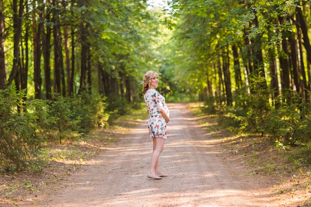 Beautiful pregnant woman relaxing outdoors