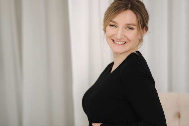 Beautiful pregnant woman sitting on chair at home woman waiting for baby