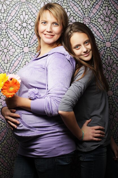 Beautiful pregnant woman with her daughter