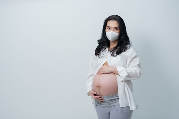 beautiful pregnant women wearing a mask