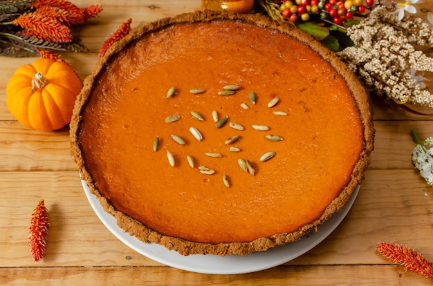 Beautiful pumpkin pie on wooden table