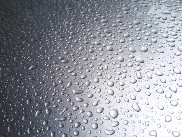 Beautiful rain dew on the top of the car.