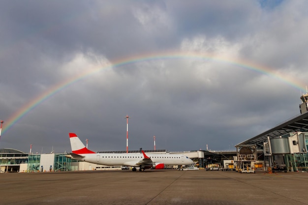 Beautiful rainbow over Basel Euroairport Plane parked at the gate