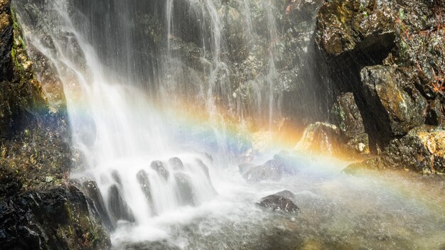 Beautiful rainbow above the waterfall in forest. Mountains of troodos, Cyprus 2020