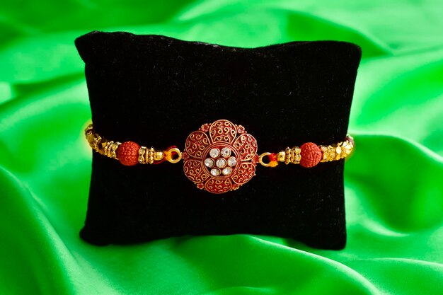 Beautiful rakhi on green silk cloth background