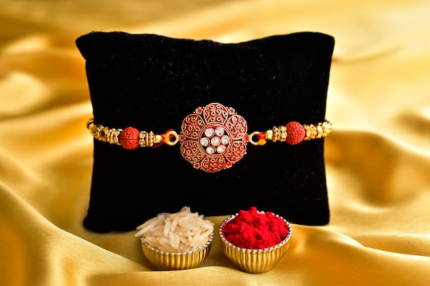 Photo beautiful rakhi with roli and chawal raksha bandhan concept