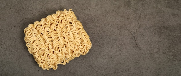 Beautiful raw instant noodles laid on gray background