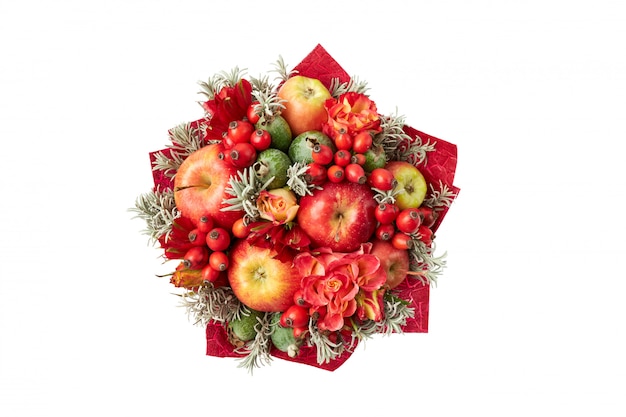 Beautiful red bright bouquet of apples, rose hips, feijoa and roses. Top view