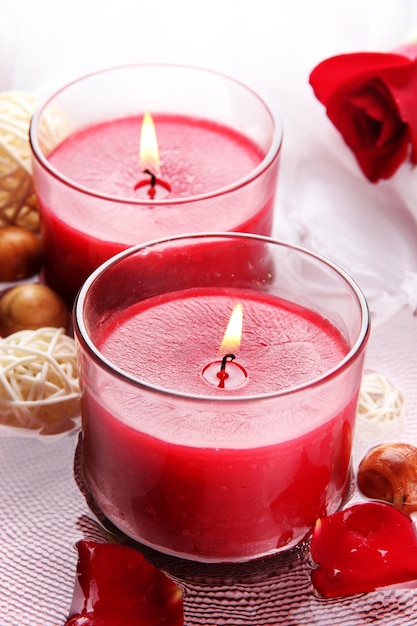 beautiful red candles with flower petals in water