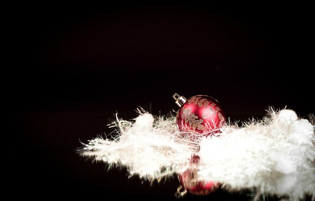 Beautiful red Christmas ball on a black background