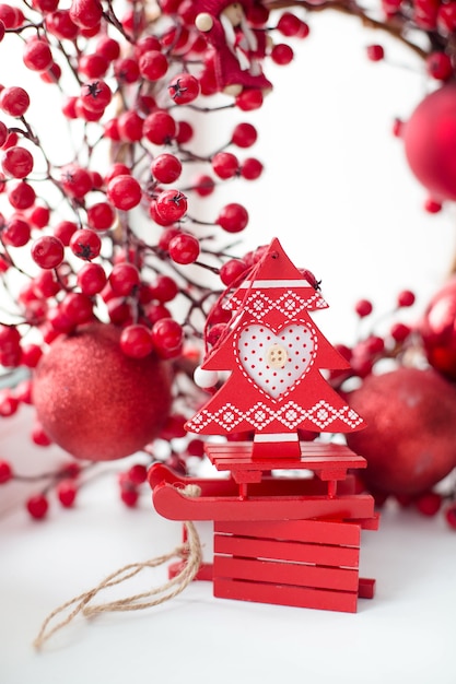 Beautiful red Christmas toys on a white table