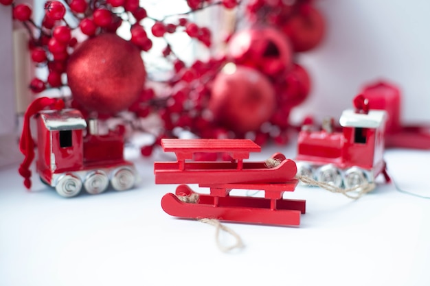 Beautiful red Christmas toys on a white table