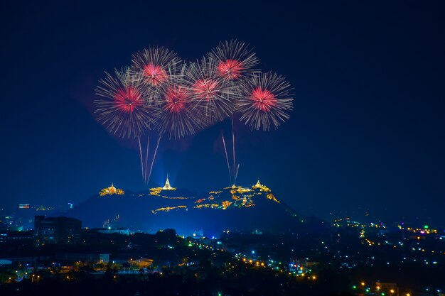 Beautiful red fireworks at night with temple on mountain view