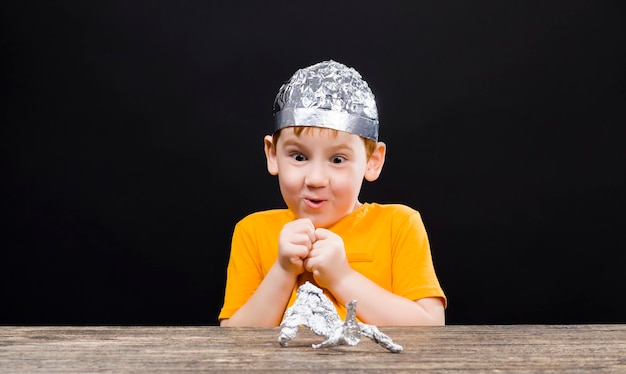 A beautiful red-haired boy with a homemade aluminum foil