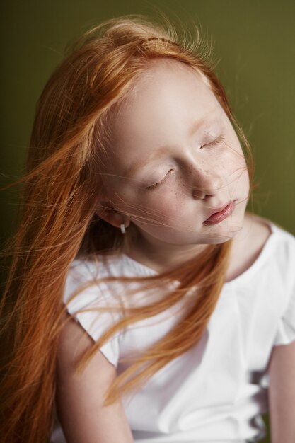 Beautiful red-haired girl with long hair 