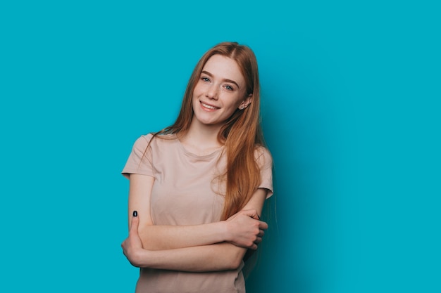 Beautiful red haired woman looking at camera smiling