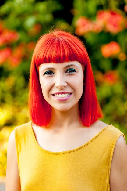 Beautiful red haired woman in a park