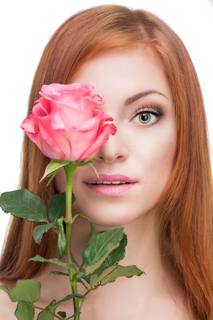 Beautiful red-haired woman with a rose