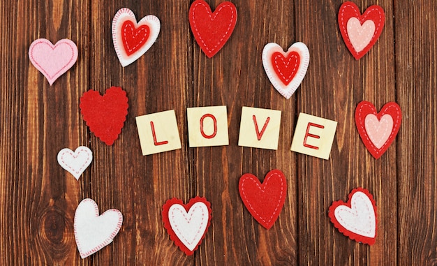 Beautiful red heart ornaments on a wooden background on Valentine's Day