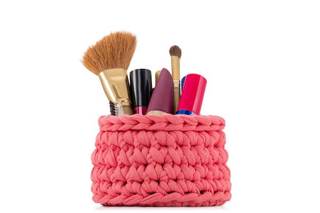 beautiful red knitted handmade female cosmetics full of makeup isolated on white background