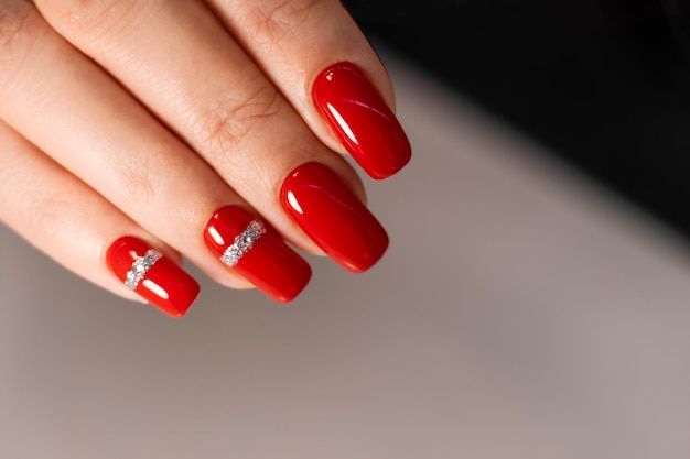 Beautiful red manicure Manicure with gel polish Closeup of young womans hands with red manicure