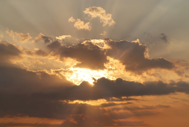 Beautiful red sky with sunbeams and clouds