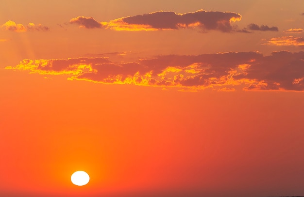 Beautiful red sunset and bright sun on the horizon