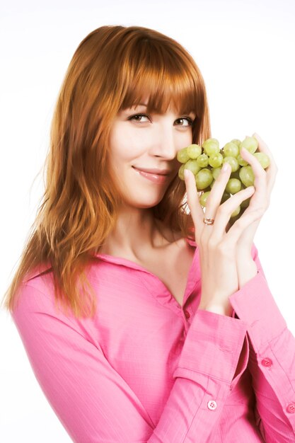 Beautiful red woman with bunch of grape.